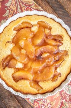 a pie with apples on it sitting on top of a table