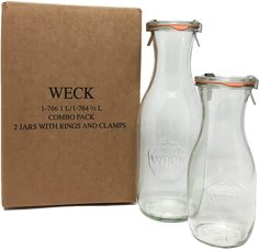 two empty glass bottles sitting next to a cardboard box on a white background with the words weck printed on it