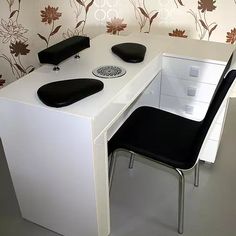 a white desk with two black chairs in front of it