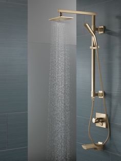 a shower head with thermostaer and hand held shower faucet in front of it