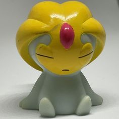 a yellow and white toy sitting on top of a table