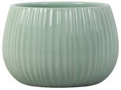 a light green vase sitting on top of a white table