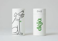 two white coffee cups with black and green designs on them, one has a dog's head drawn on it