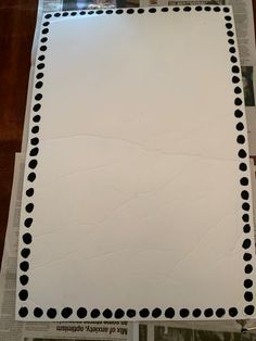 a piece of paper with black dots on it