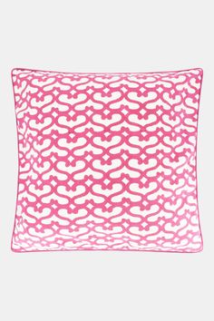 a pink and white pillow with an intricate design on the front, sitting on a gray surface