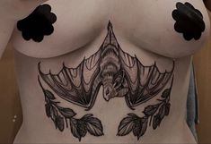 a woman's breast with black ink on it and an image of a bird