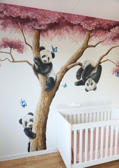 a baby's room painted with pandas and cherry blossoms