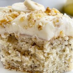 a close up of a piece of cake on a plate with bananas in the background