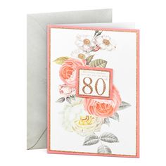 an 80th birthday card with pink roses and white flowers on the front, in gold foil