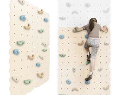 a woman climbing up the side of a rock wall