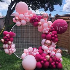 the balloon arch is decorated with pink, gold and white balloons for a mother's day celebration