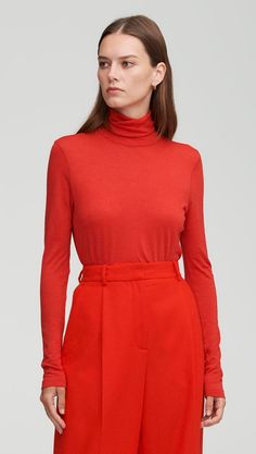 Made of Italian wool silk, this versatile style features a slim turtleneck neck that’s made for sporting countless ways. The super-soft fabric offers both comfort and performance, ideal for layering under suiting or shirting, or dressing down with denim. Luxury Red Top With Ribbed Collar, Red Ribbed Turtleneck Top, Red Fitted Turtleneck Top, Dark Red Turtleneck, Red Fitted High Neck Sweater, Go Browns, Pleated Trousers, Brown Plaid, Work Wear Women