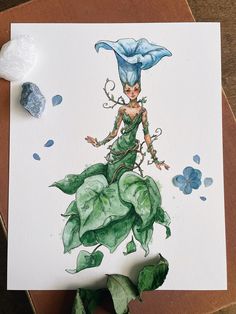 a watercolor painting of a woman in green dress and blue hat sitting on top of leaves