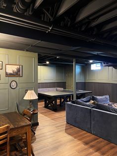 a living room filled with furniture and a ping pong table