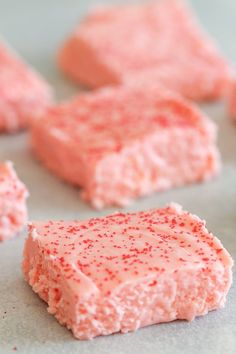 there are pieces of pink cake on the baking sheet