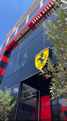 the ferrari logo is displayed on the side of a red, black and white building