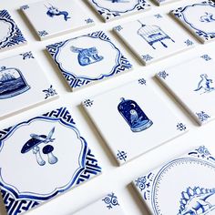 many blue and white tiles are arranged on the table top, all with different designs