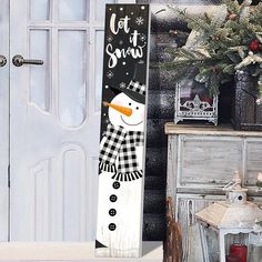 a snowman standing in front of a white door