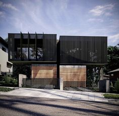 an architecturally designed house with wooden slats on the front and side walls is shown