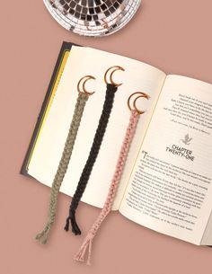 an open book with three tassels attached to it