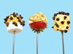 four dessert lollipops with different toppings on them