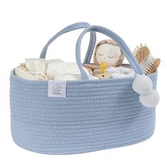 a blue knitted basket filled with baby items