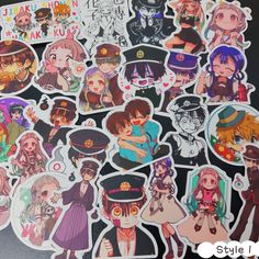 various anime stickers on a table