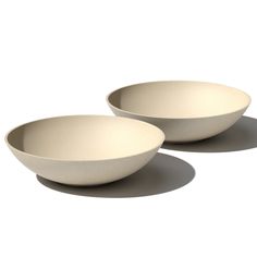 two white bowls sitting next to each other