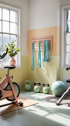 there is a bike, kettles and exercise equipment on the floor in this room