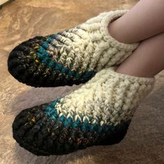 someone is wearing slippers made out of yarn