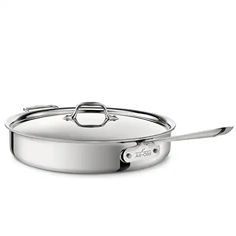 a stainless steel skillet with lid and handle on a white background for use in cooking