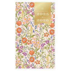 a pink and green floral notebook with gold foil on the front, featuring flowers in various colors