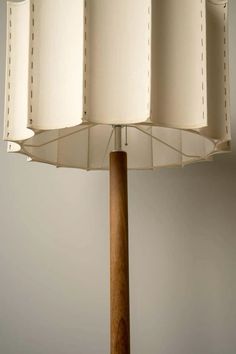 a lamp that is on top of a wooden pole and has four lamps in it