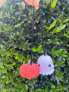 two crocheted hearts hanging from a tree