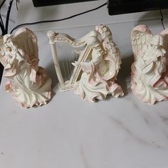 three figurines sitting on top of a table