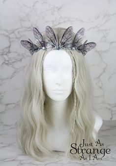 This is a must-have for all fairies! Here we have a beautiful tiara, fit for any fairy queen! This enchanting crown is comprised entirely of my handmade silver bee fairy wings. The wings are attached a metal silver band, and adorned with clear gemstones. The wings are lightweight and far more durable than their glassy appearance might suggest! One size ought to fit all, but do message me if you are unsure. This tiara is best suited to adults over children, due to small parts. This is definitely a head turner! This beautiful crown is absolutely perfect for any fairy costumes and cosplays, Pagan or Wiccan events, weddings, proms - or even everyday wear. This would make the perfect addition to your festival outfit, bridal attire, renaissance costume ... the possibilities are truly endless. Pl Bee Wings, Fairy Crown, Fairy Queen, Hair Wreaths, Beautiful Tiaras, Metal Headbands, Fairy Wings, Fairy Costume, Festival Outfit