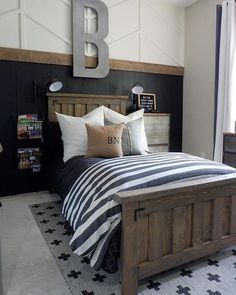 a bedroom with black and white striped bedding, wooden headboard and nightstands