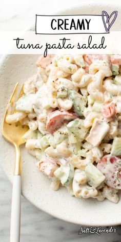 a white plate topped with pasta salad next to a fork