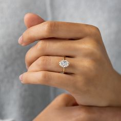 a woman's hand with a diamond ring on it