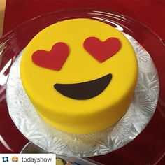 a smiley face cake with hearts on it