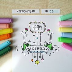 a happy birthday card with colored crayons and markers on the table next to it