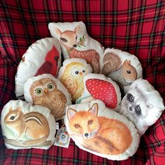 a bunch of pillows that have animals on them in the shape of owls and foxes