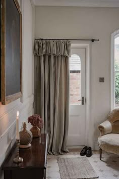 a living room filled with furniture and a white door