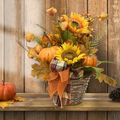 a basket filled with sunflowers sitting on top of a wooden shelf next to a pine cone