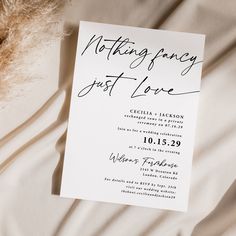 a white wedding card with writing on it sitting on top of a bed next to a teddy bear