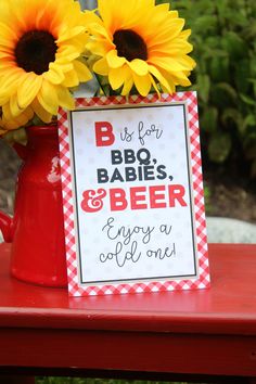 sunflowers are in a red watering can with a sign that says bbq babies and beer