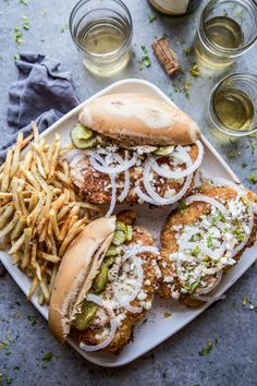 two chicken burgers and french fries on a plate