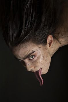 a woman with freckled hair sticking out her tongue