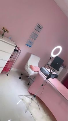 a room with pink walls and white furniture