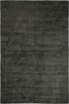 an area rug with dark green tones